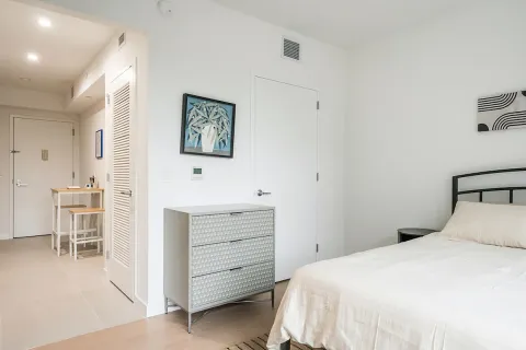 a bedroom with a bed and a desk