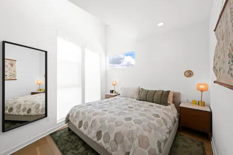 a bedroom with a bed and a window