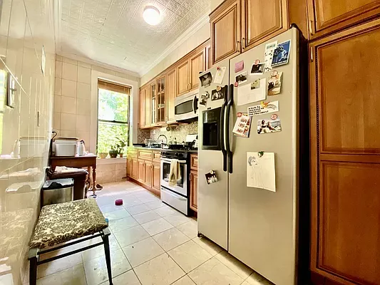 a kitchen with stainless steel appliances granite countertop a refrigerator and a stove
