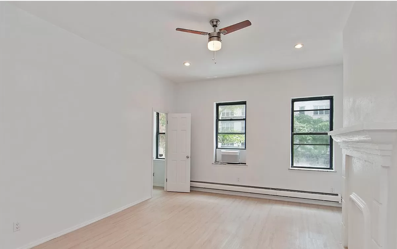 218 3rd Avenue, Unit 2 Manhattan, NY 10003 - Photo 5 of 9 an empty room with windows and fan