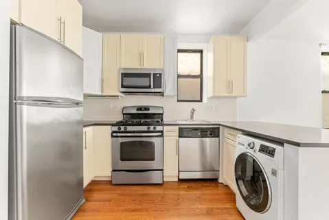 a kitchen with a stove a washer and dryer