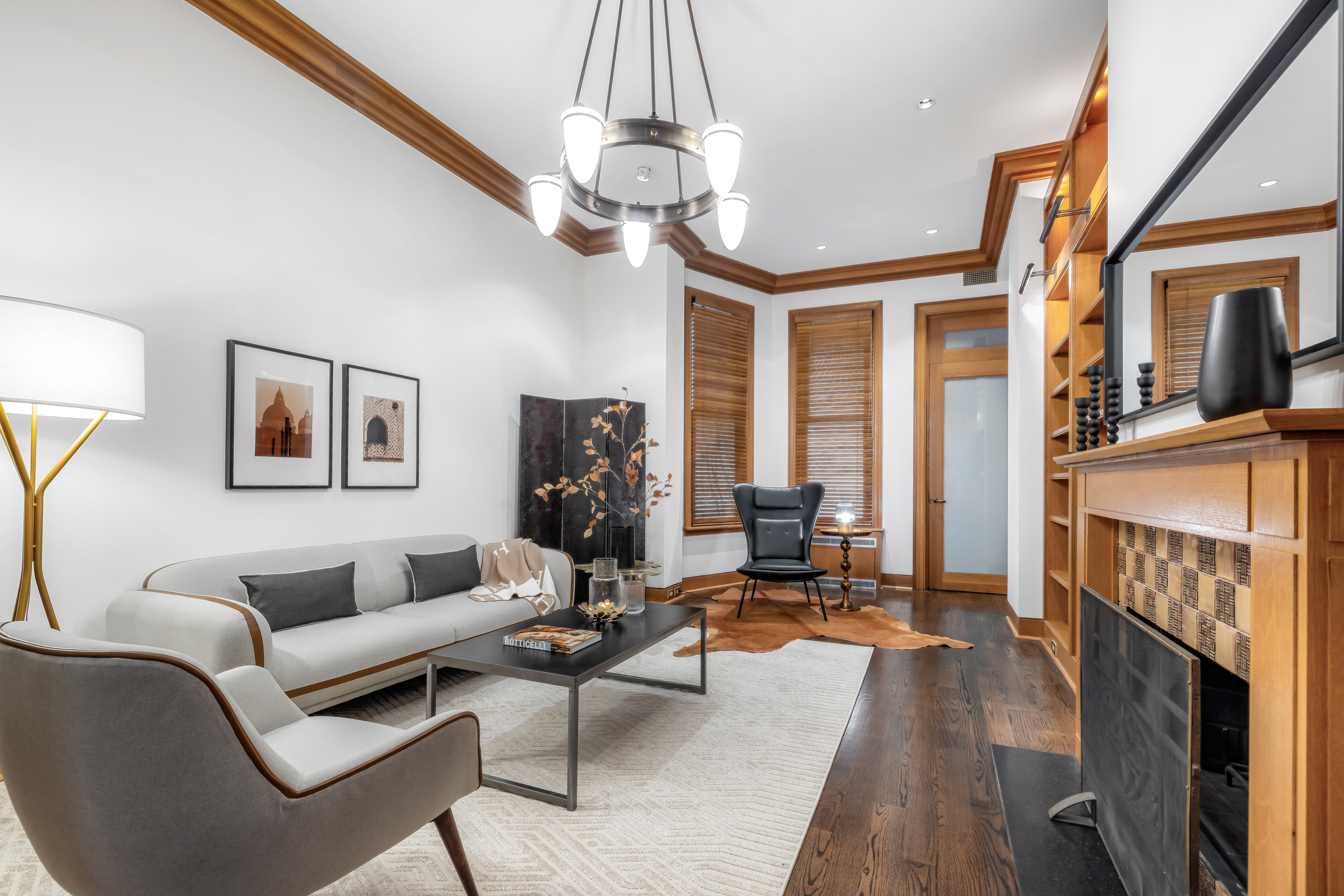 22 East 78th Street Manhattan, NY 10075 - Photo 3 of 23 a living room with furniture a chandelier and a fireplace
