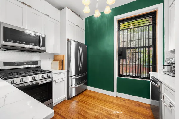 a kitchen with a refrigerator and a sink