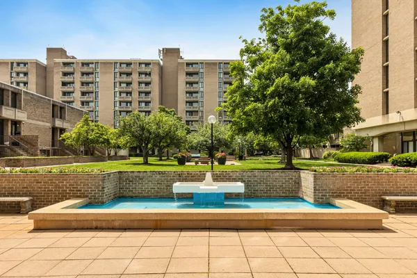 a view of a building with yard and trees