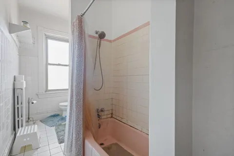 a bathroom with a sink a toilet and a window