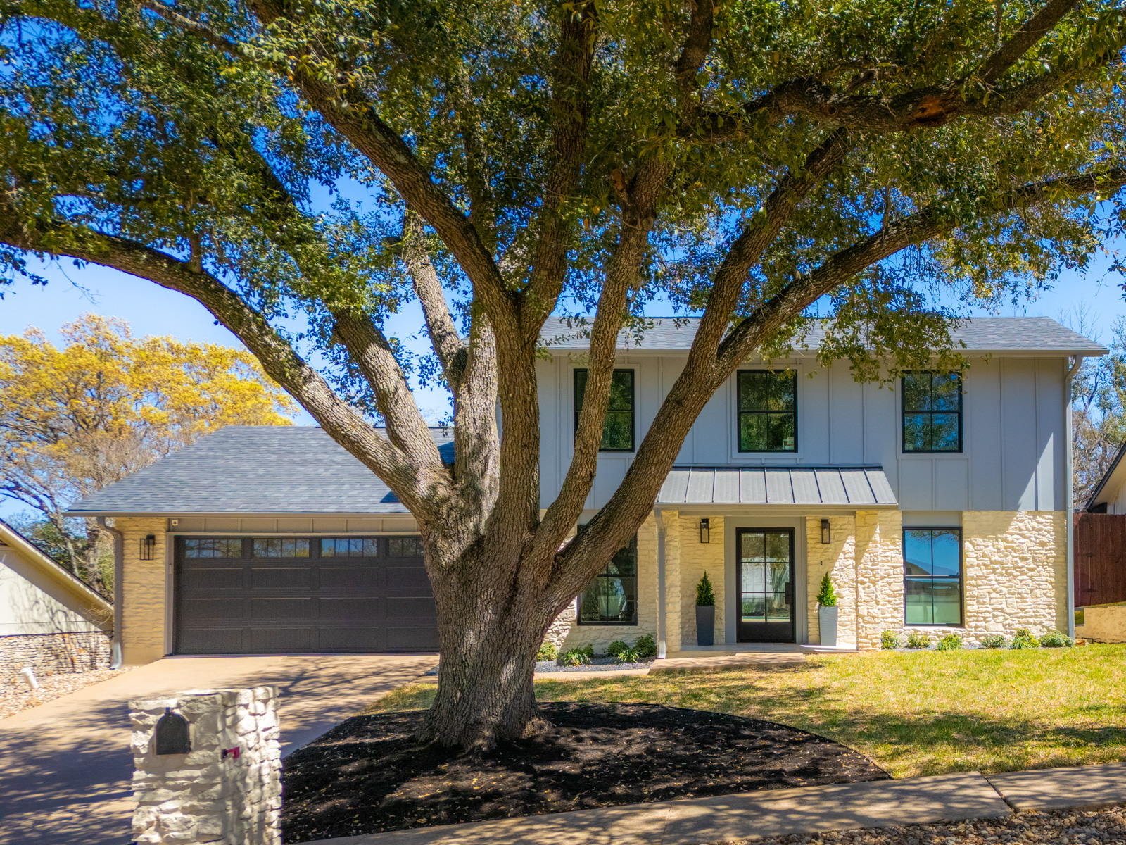 1317 Thaddeus Cove Austin, TX 78746 - Photo 18 of 22 a front view of a house with a yard