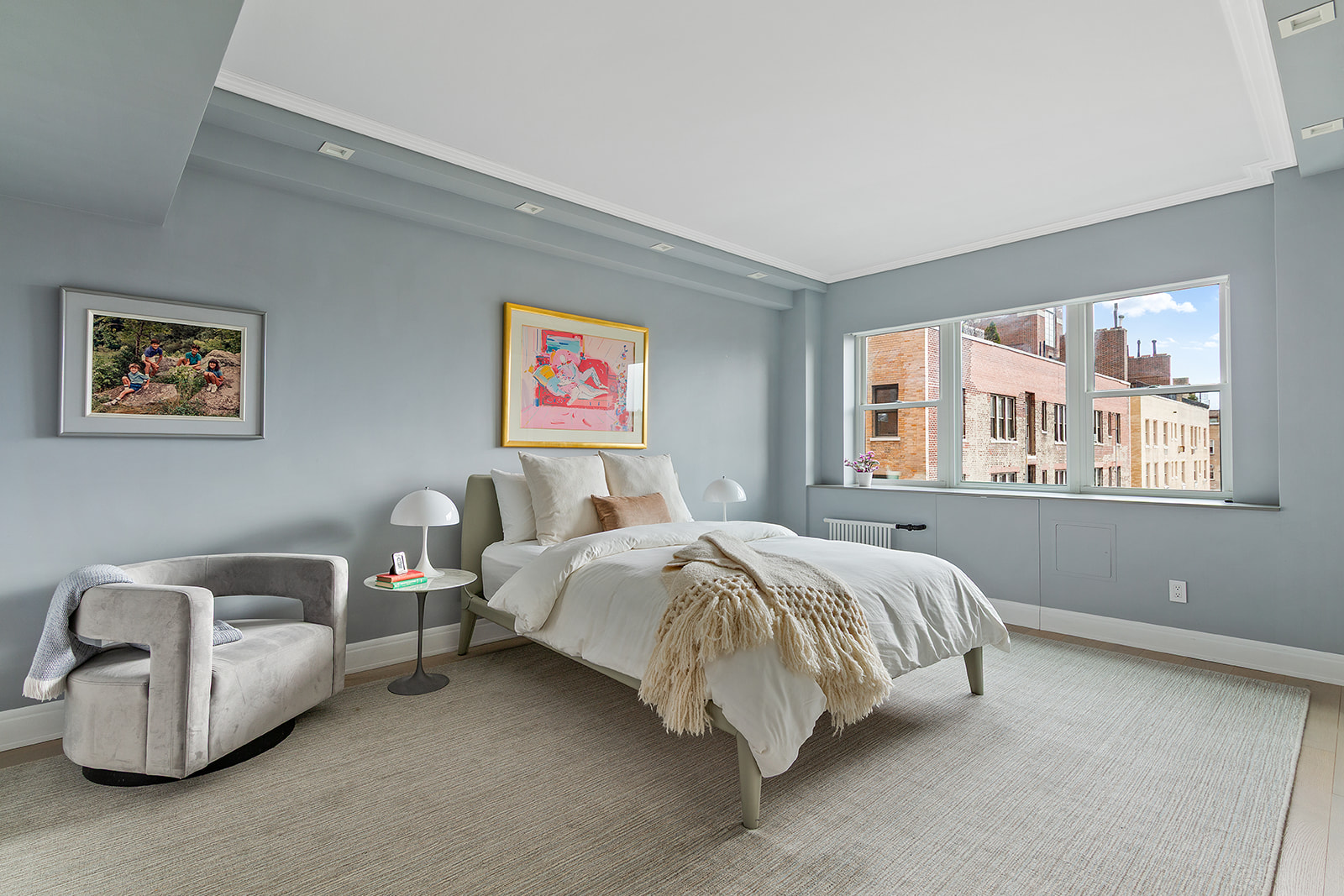 165 East 72nd Street, Unit 17L Manhattan, NY 10021 - Photo 7 of 12 a bedroom with bed and a couch