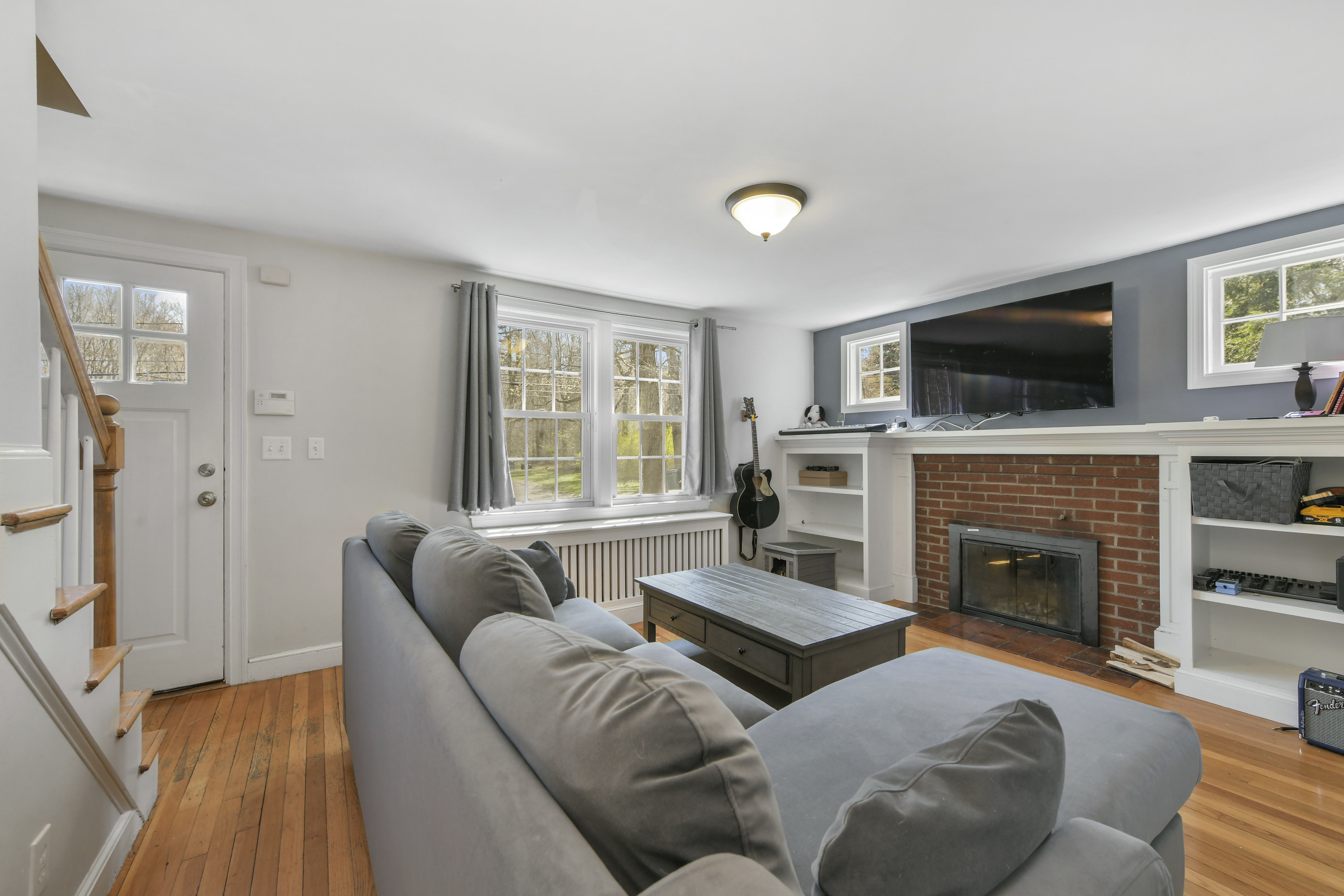 a living room with furniture a flat screen tv and a fireplace