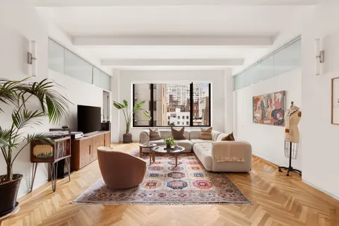 a living room with furniture a flat screen tv and a large window
