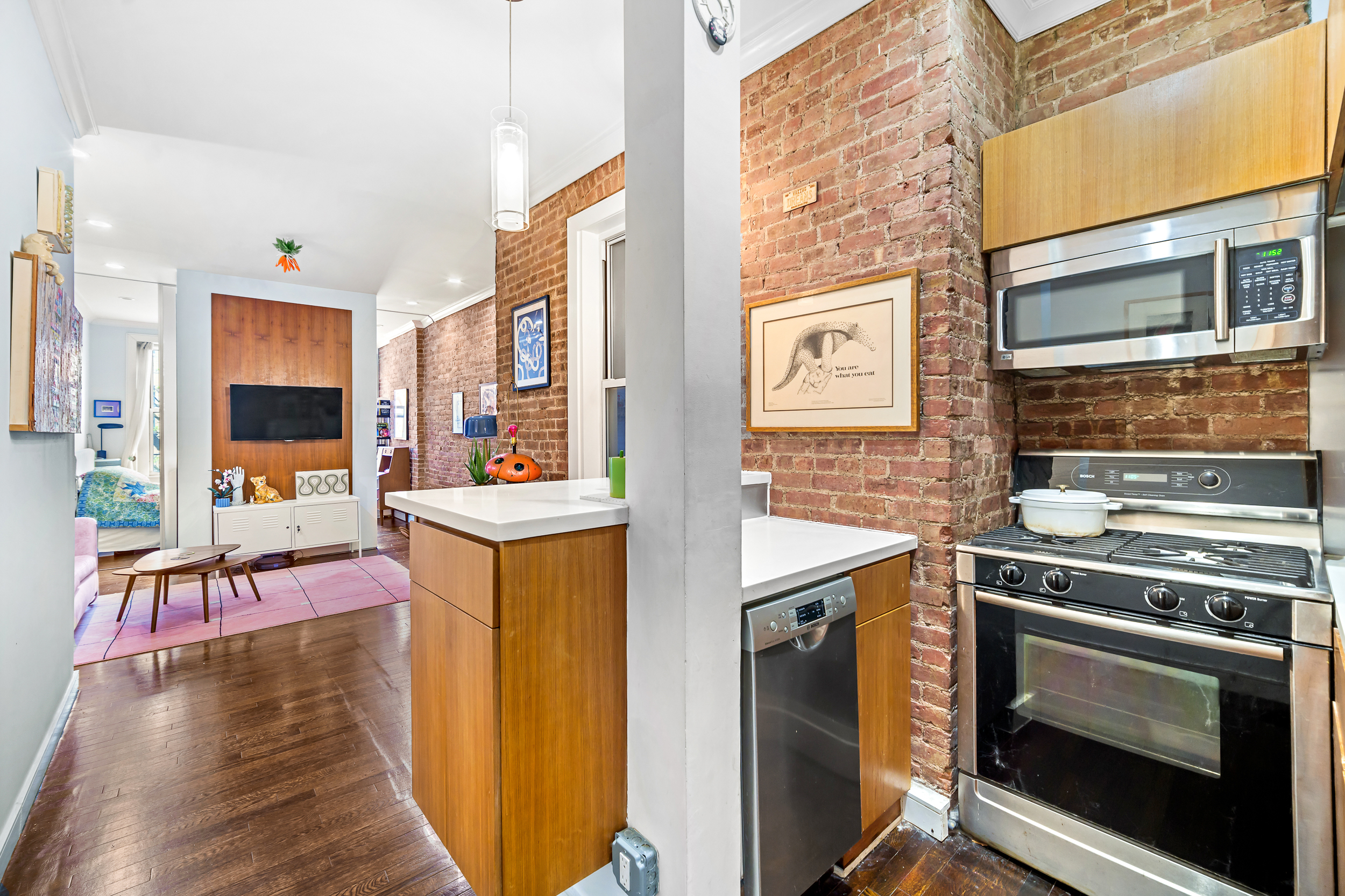 330 West 17th Street, Unit 3E Manhattan, NY 10011 - Photo 3 of 8 a kitchen with stainless steel appliances granite countertop a stove and a refrigerator