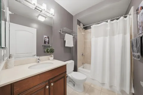 a bathroom with a sink vanity granite and toilet