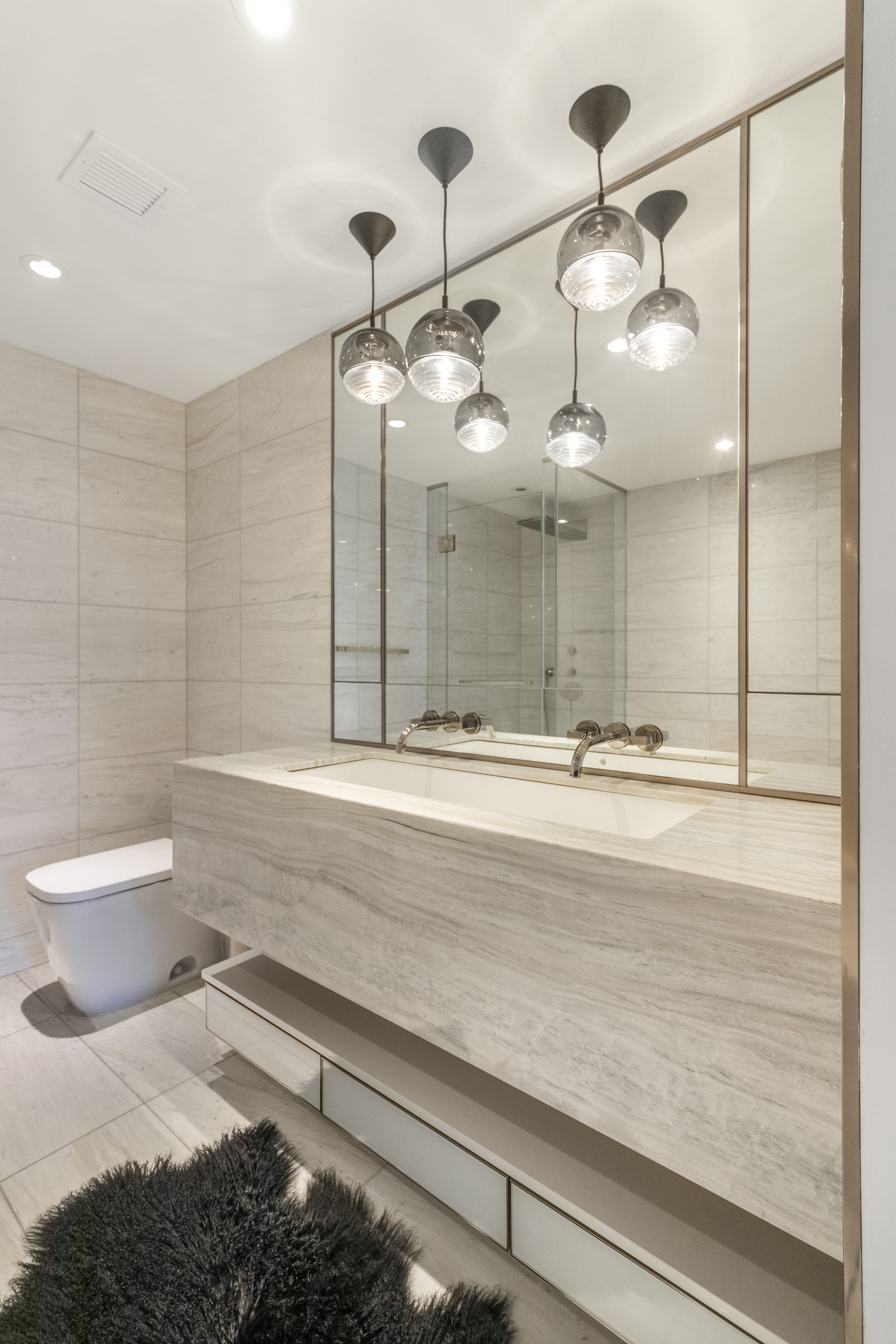 135 West 52nd Street, Unit 23C Manhattan, NY 10019 - Photo 10 of 19 a bathroom with a sink a toilet and shower