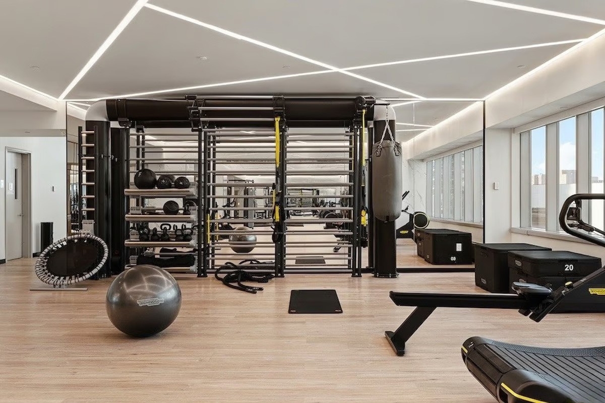 46-30 Center Boulevard, Unit 610 Queens, NY 11109 - Photo 12 of 19 a room with gym equipment and a large window