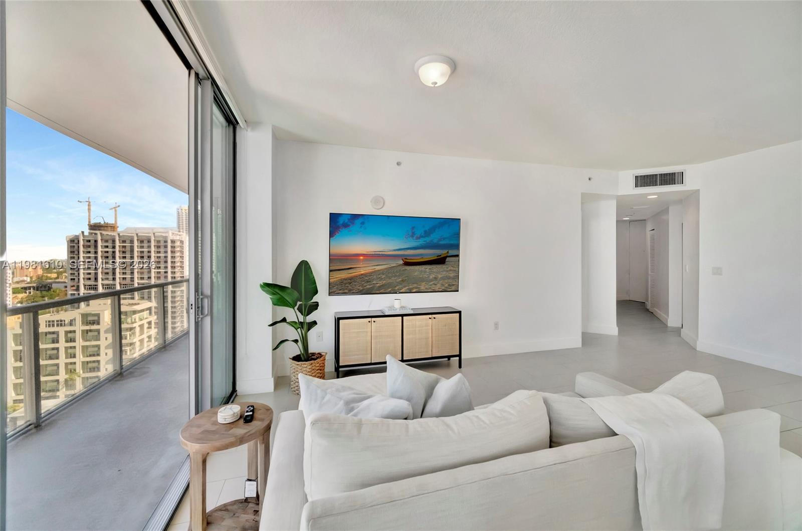 79 Southwest 12th Street, Unit 2201S Miami, FL 33130 - Photo 8 of 33 a living room with furniture and a flat screen tv