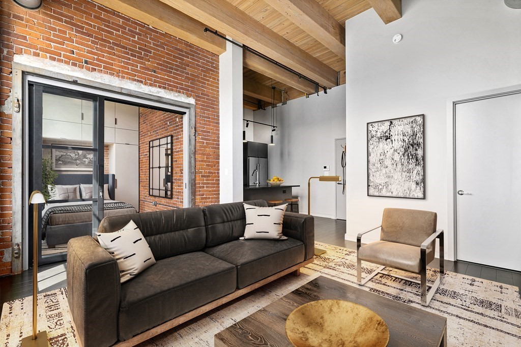 319 A Street, Unit 211 Boston, MA 02210 - Photo 2 of 24 a living room with furniture and a large window