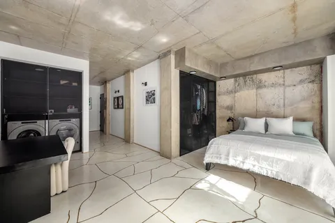 a bedroom with a bed and a view of bathroom