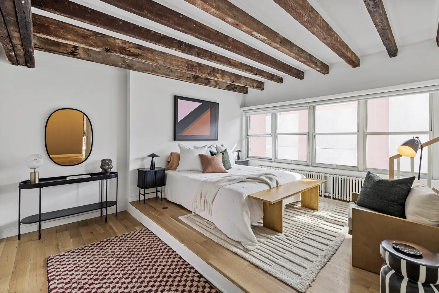 a living room with furniture a rug and a large window
