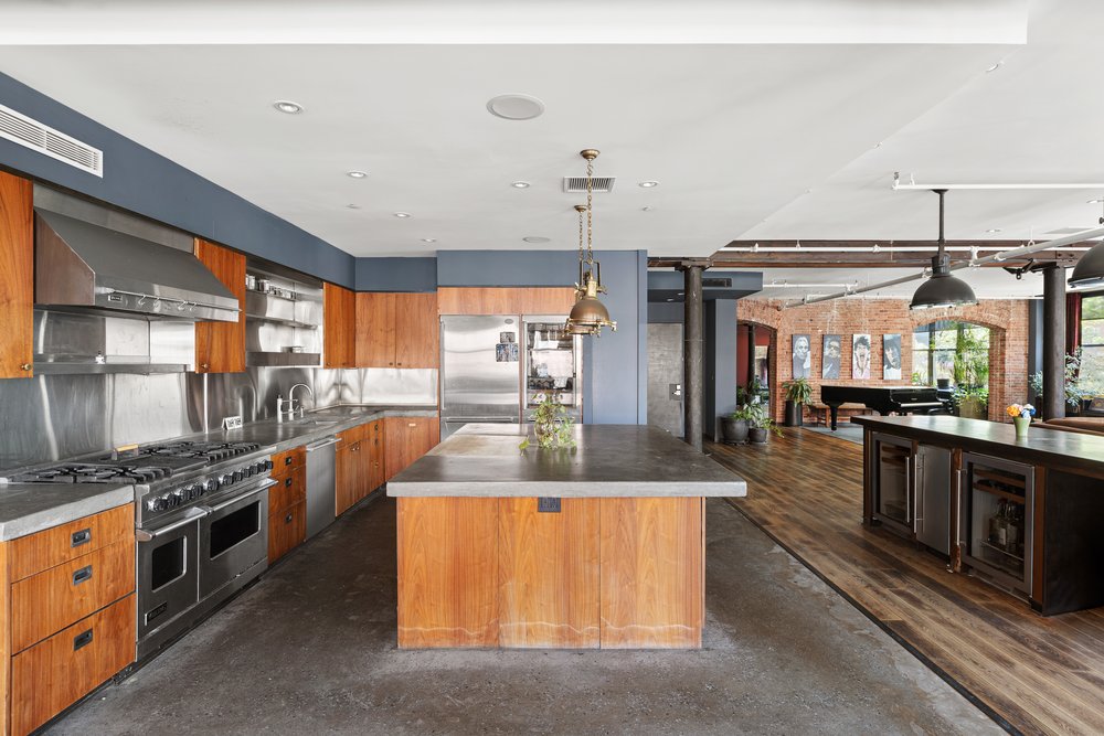 345 West 13th Street, Unit 2DEG Manhattan, NY 10014 - Photo 5 of 14 a kitchen with stainless steel appliances granite countertop a stove and a sink