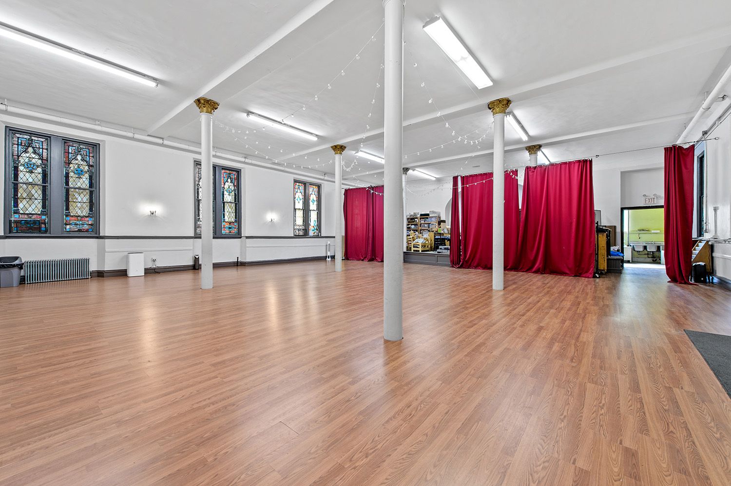 a view of a room with wooden floors and windows