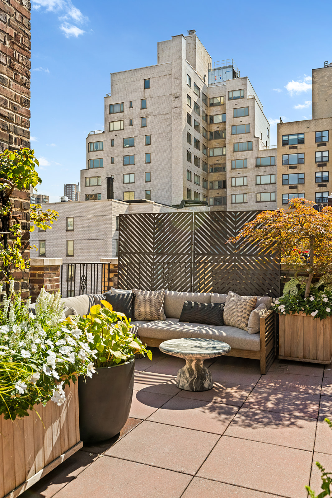 151 East 83rd Street, Unit PHB Manhattan, NY 10028 - Photo 9 of 11 a view of a patio with couches and potted plants