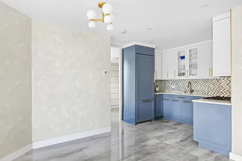 a bathroom with a granite countertop sink a mirror and shower