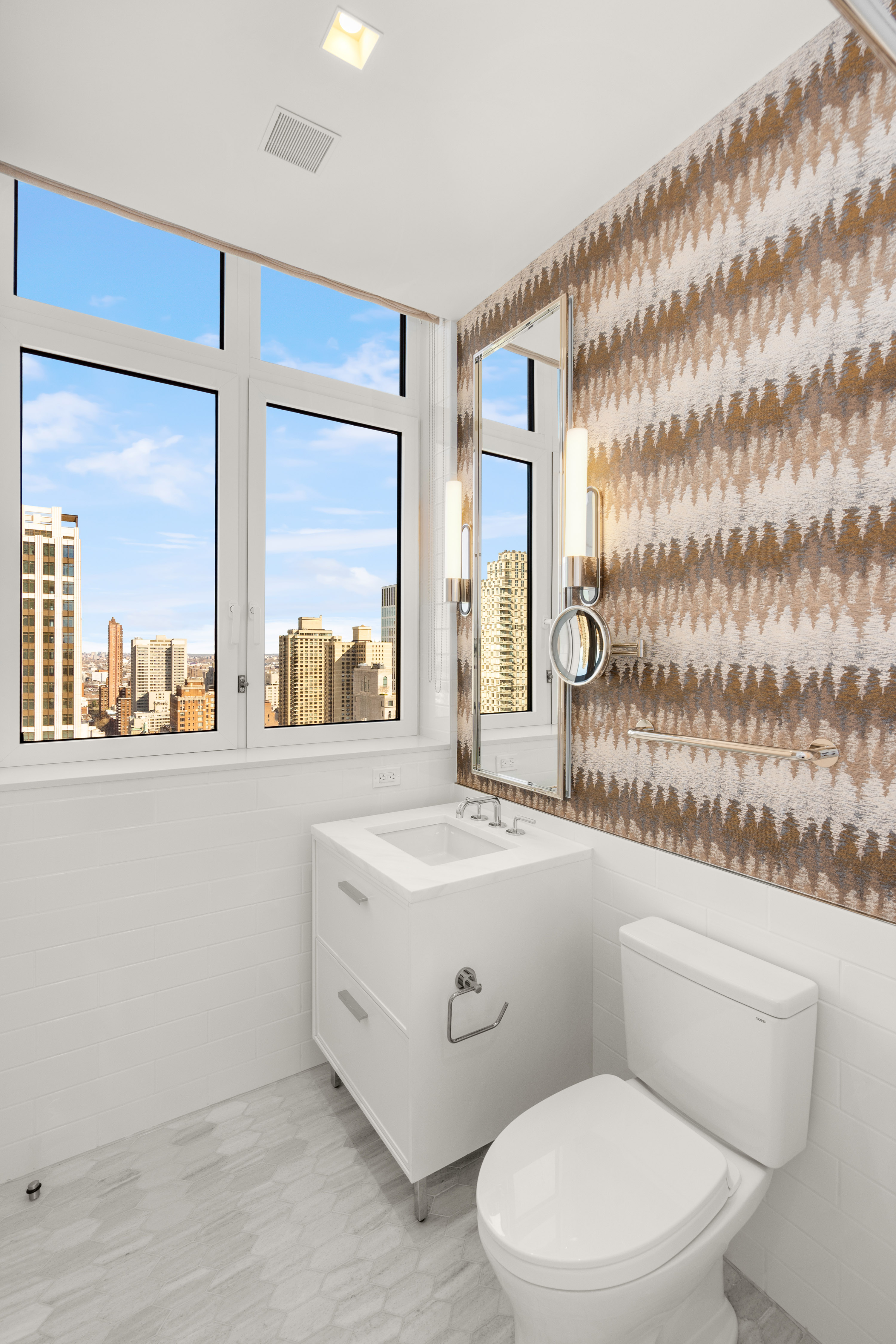 200 East 83rd Street, Unit 24C Manhattan, NY 10028 - Photo 15 of 35 a white toilet sitting next to a bathroom sink