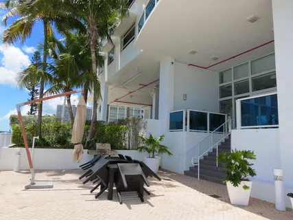 a view of a house with a yard and sitting area