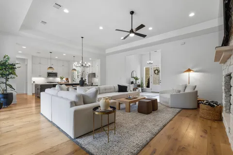 a living room with furniture and a chandelier