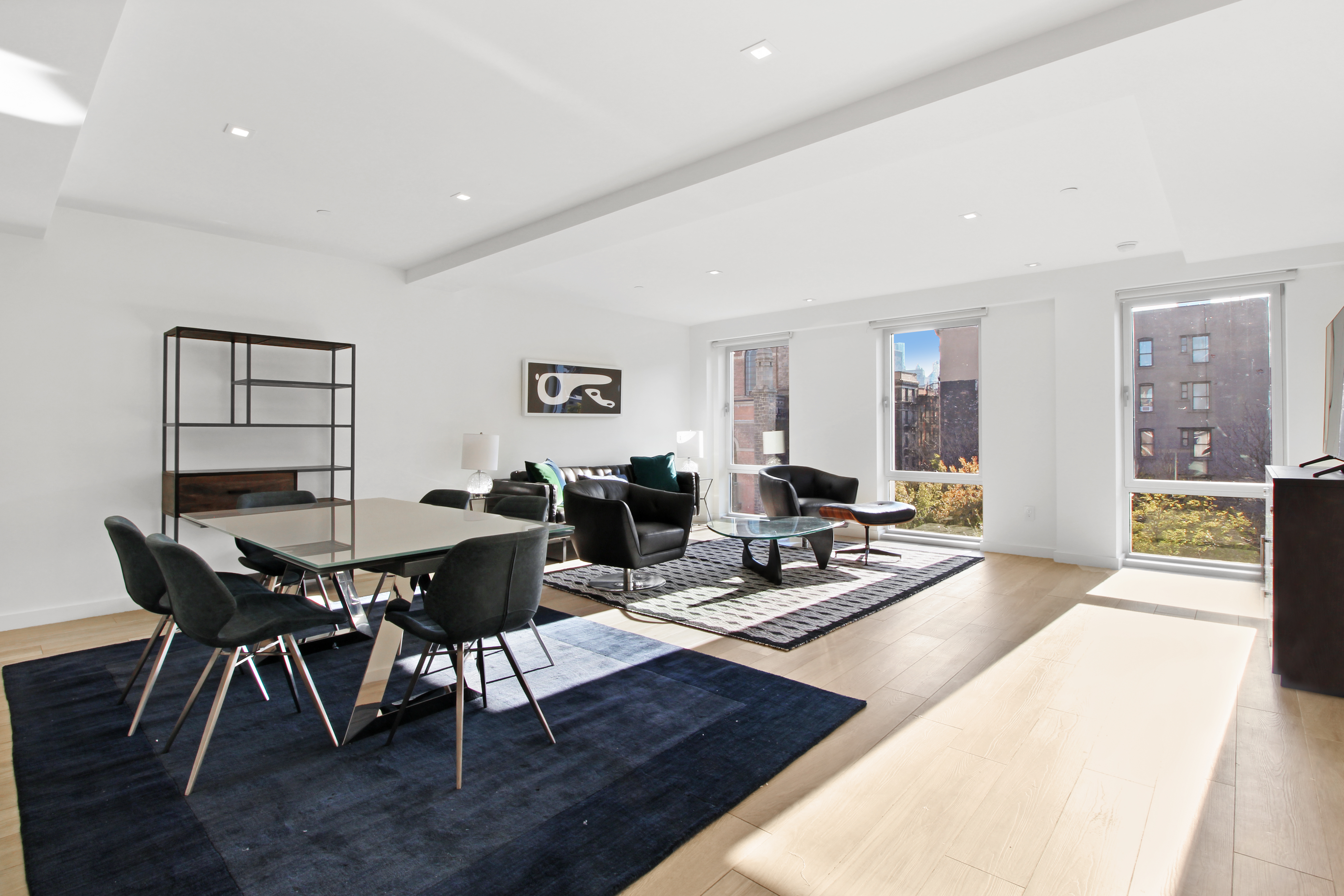 136 West Houston Street, Unit 4 Manhattan, NY 10012 - Photo 1 of 14 a living room with furniture a wooden floor and next to a window
