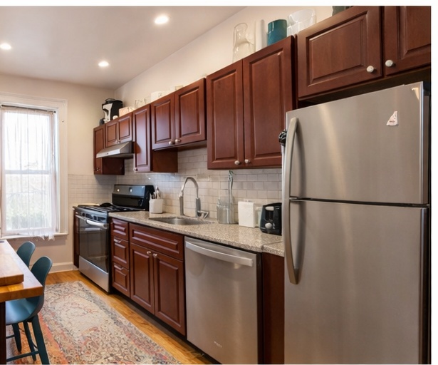 481 9th Street, Unit 4 Brooklyn, NY 11215 - Photo 26 of 33 a kitchen with stainless steel appliances granite countertop a refrigerator a sink dishwasher a stove top oven a refrigerator and cabinets with wooden floor