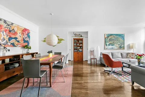 a dining room with furniture and wooden floor