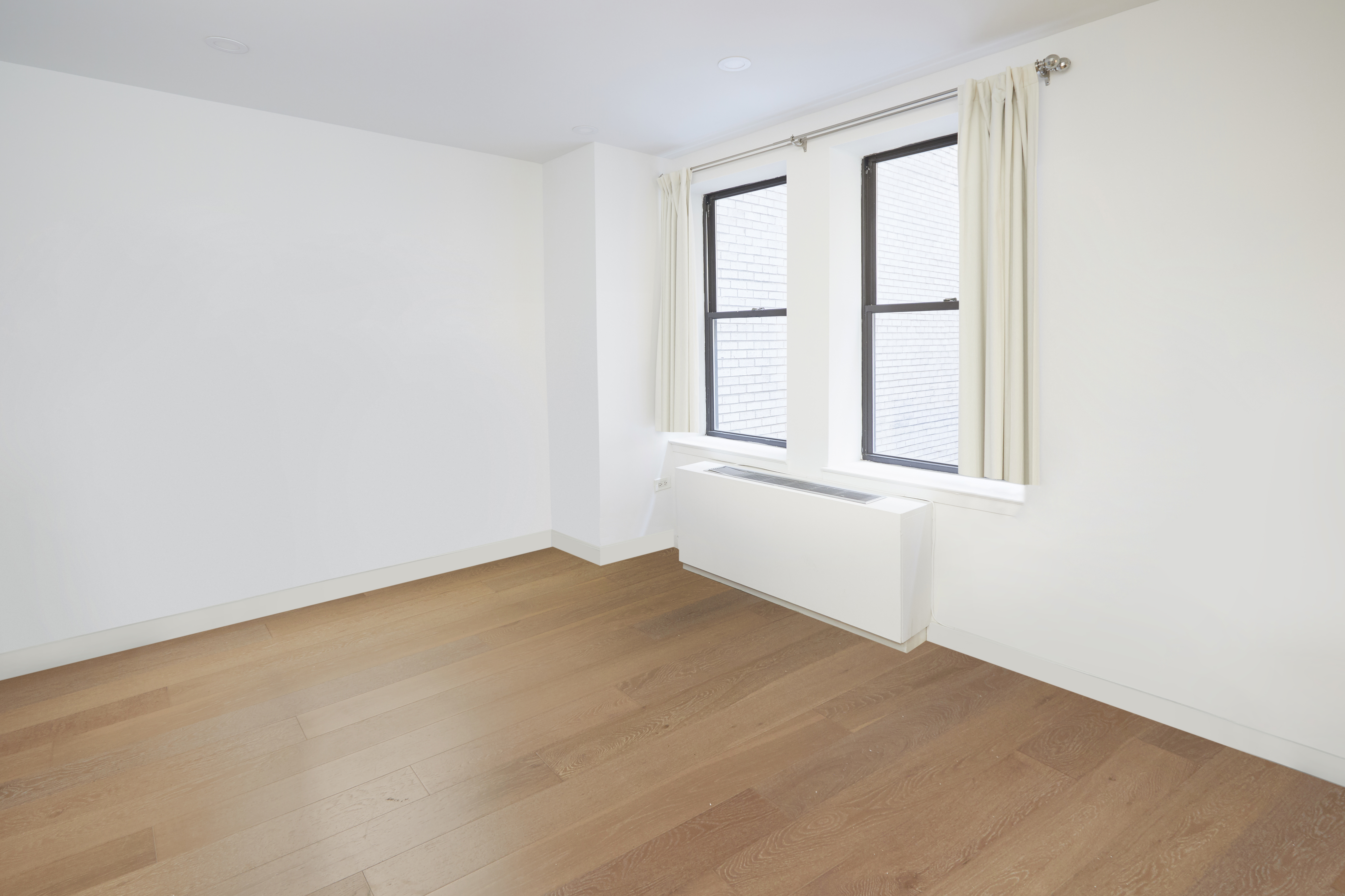 150 West 51st Street, Unit 1528 Manhattan, NY 10019 - Photo 20 of 21 an empty room with windows