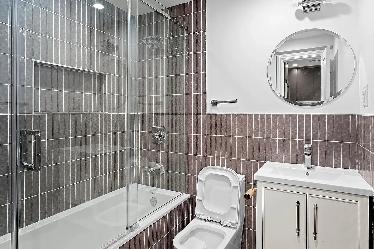 94 Pilling Street, Unit 1 Brooklyn, NY 11207 - Photo 6 of 6 a bathroom with a sink mirror bathtub and toilet
