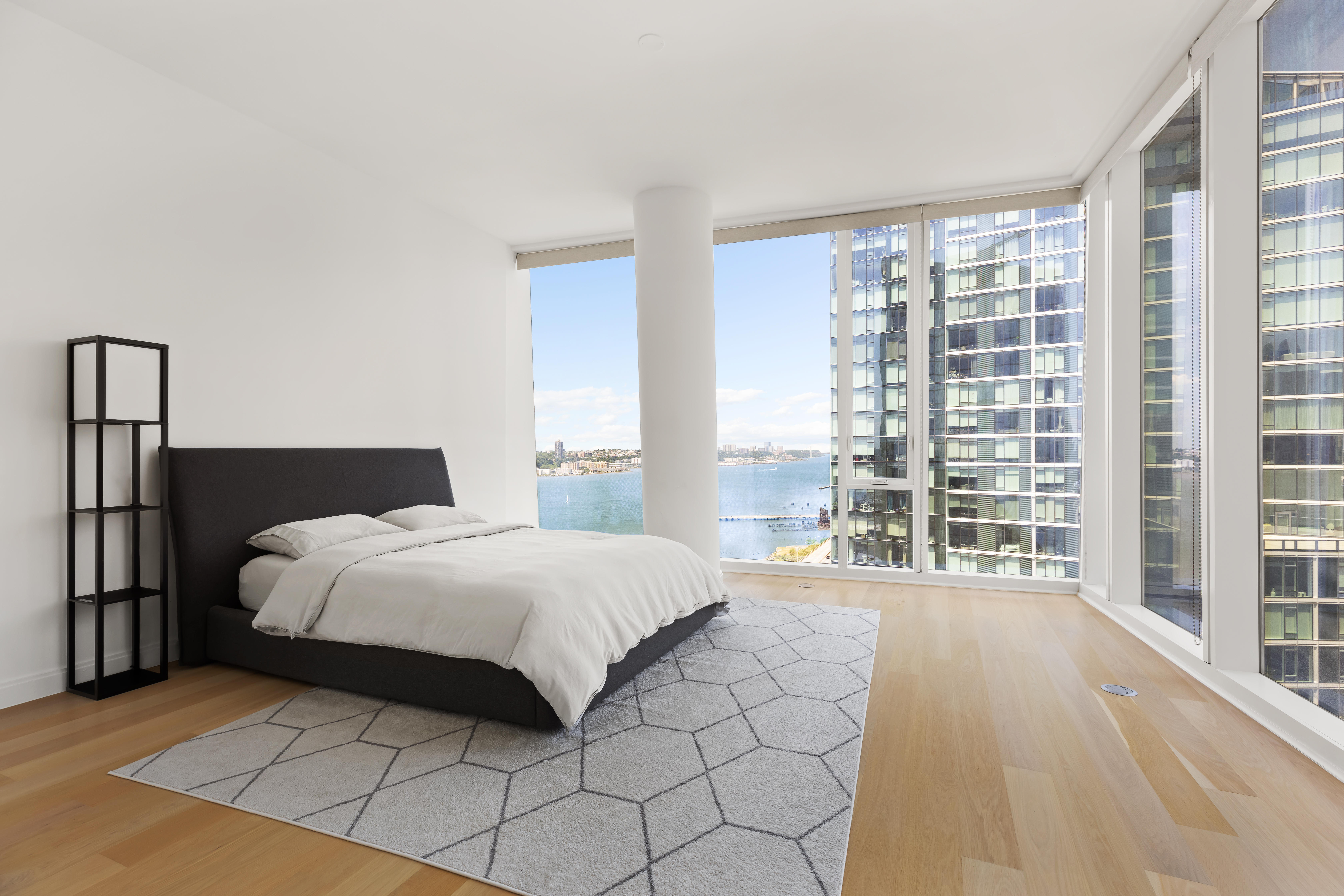 10 Riverside Boulevard, Unit 27D Manhattan, NY 10069 - Photo 5 of 21 a bedroom with a bed and a large window