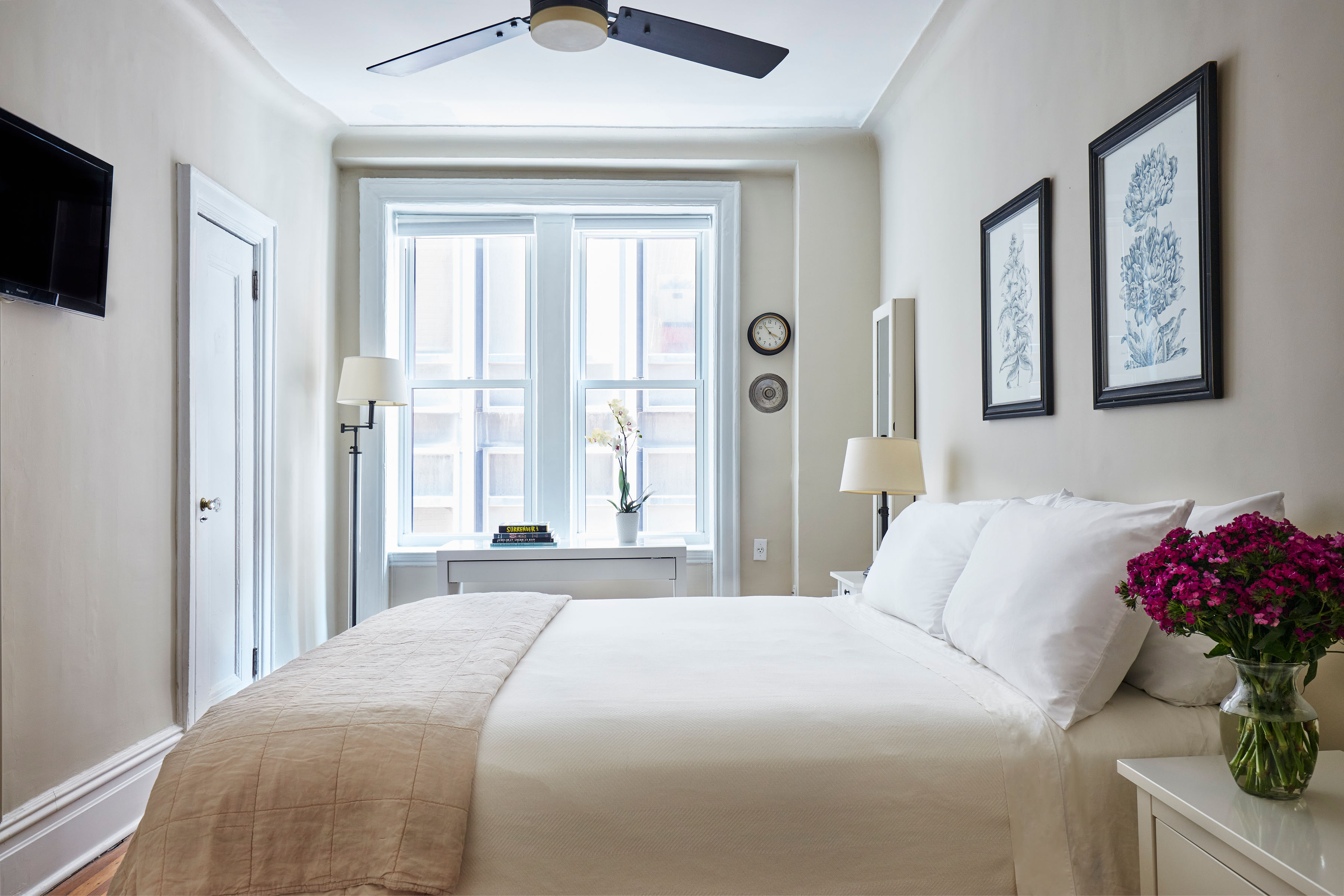 200 West 54th Street, Unit 4H Manhattan, NY 10019 - Photo 4 of 8 a bedroom with a large bed and a window