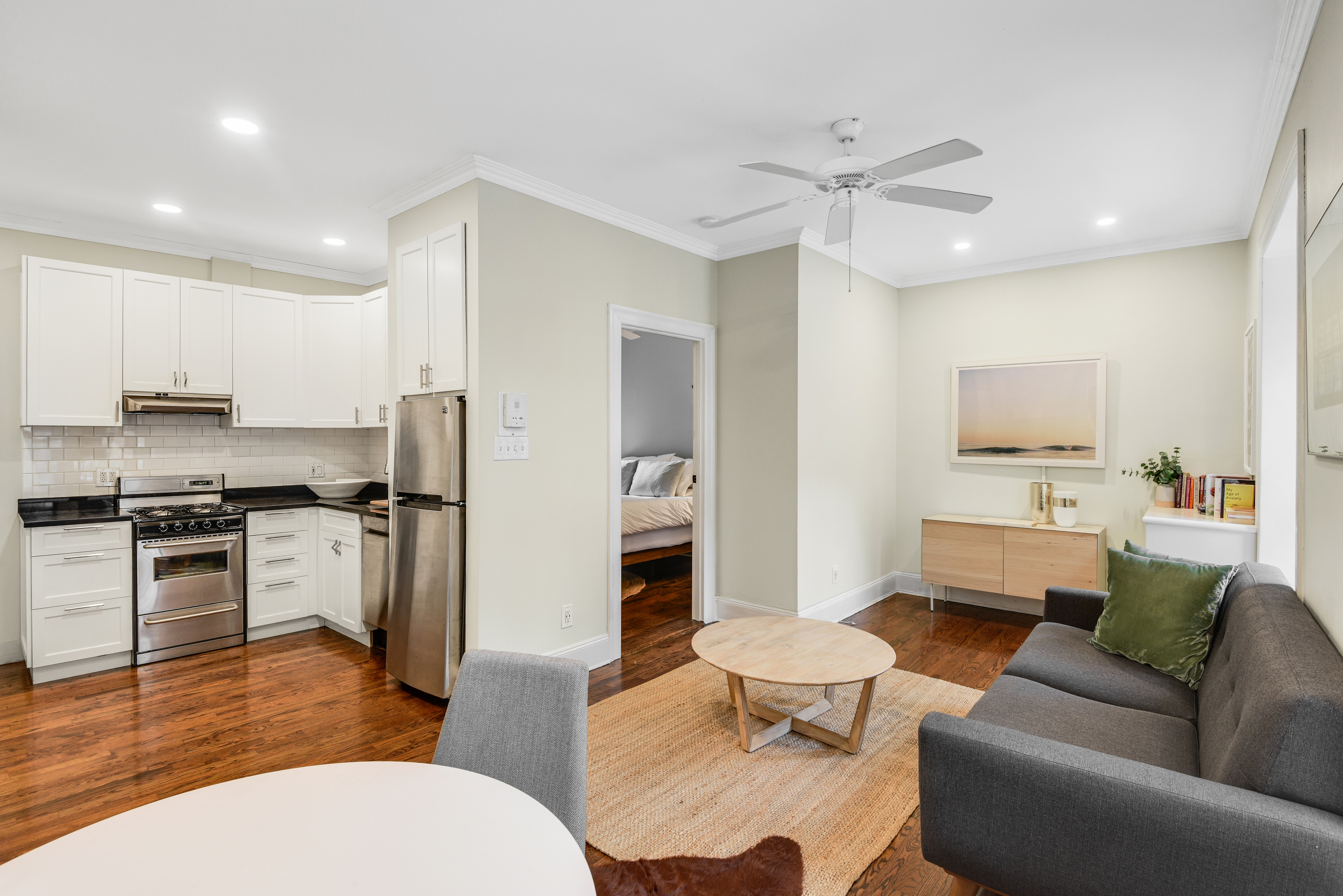 322 6th Street, Unit 2 Brooklyn, NY 11215 - Photo 2 of 11 a living room with stainless steel appliances furniture a rug and a kitchen view