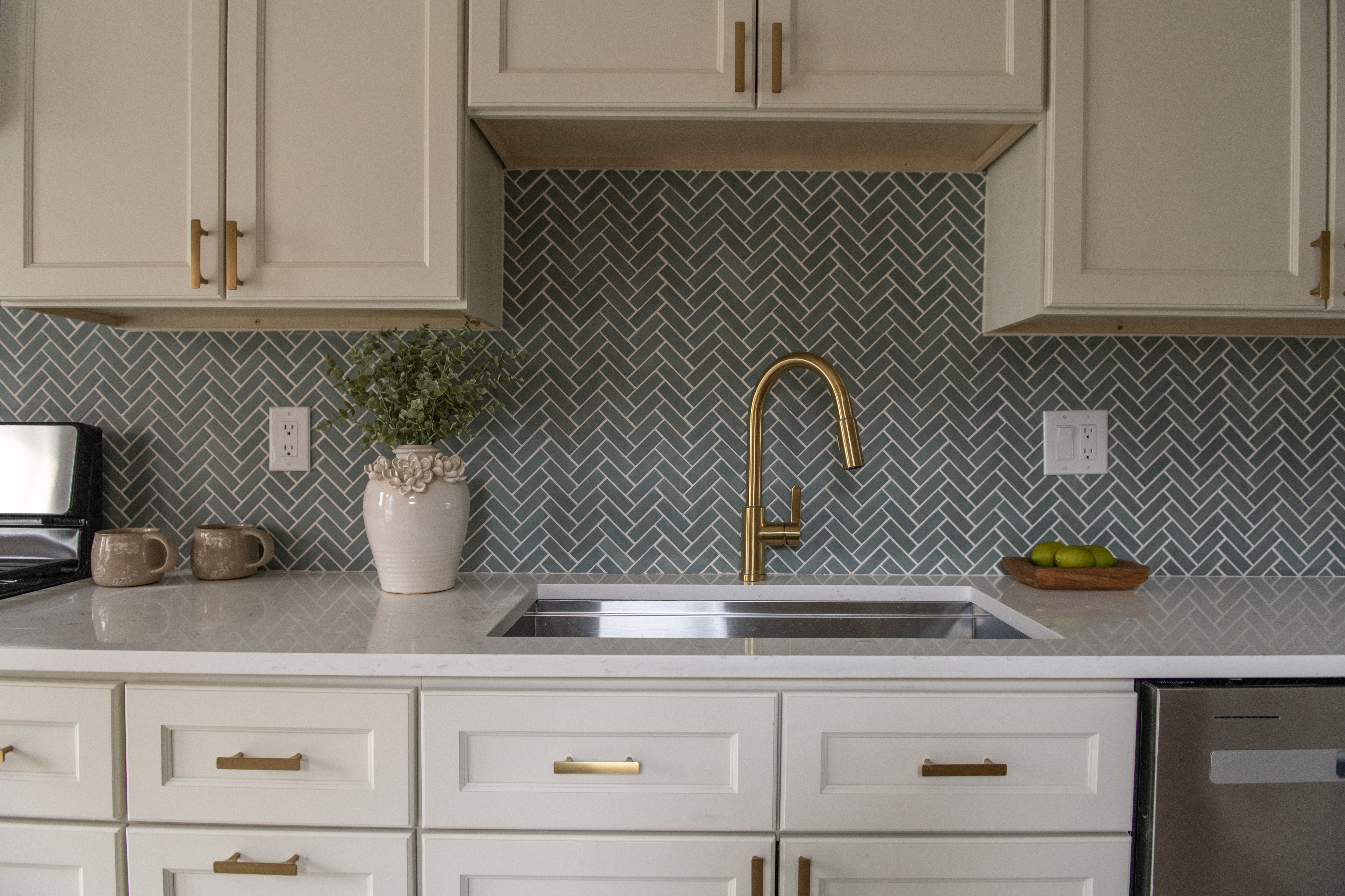 a kitchen with a sink a stove and cabinets