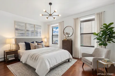 a bedroom with a bed and a chandelier