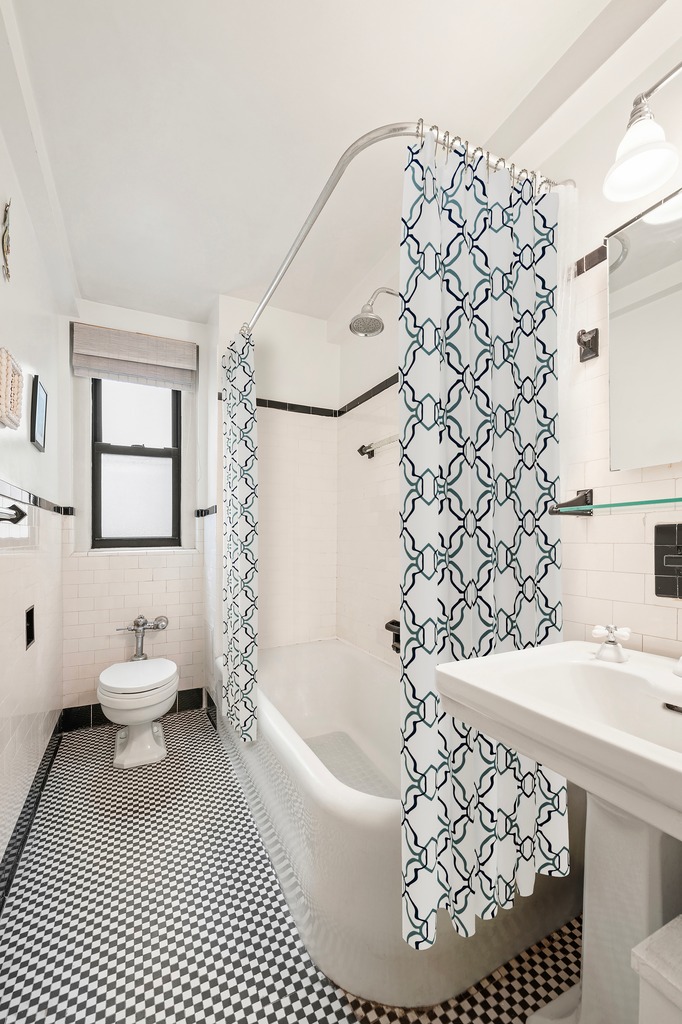 205 East 78th Street, Unit 12J Manhattan, NY 10075 - Photo 6 of 9 a bathroom with a sink toilet and shower