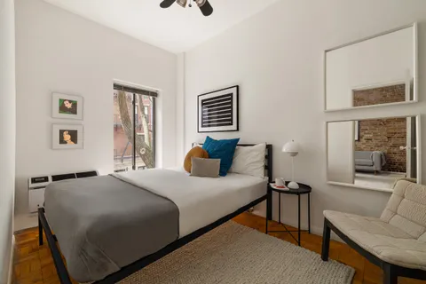 a bedroom with a bed and a couch
