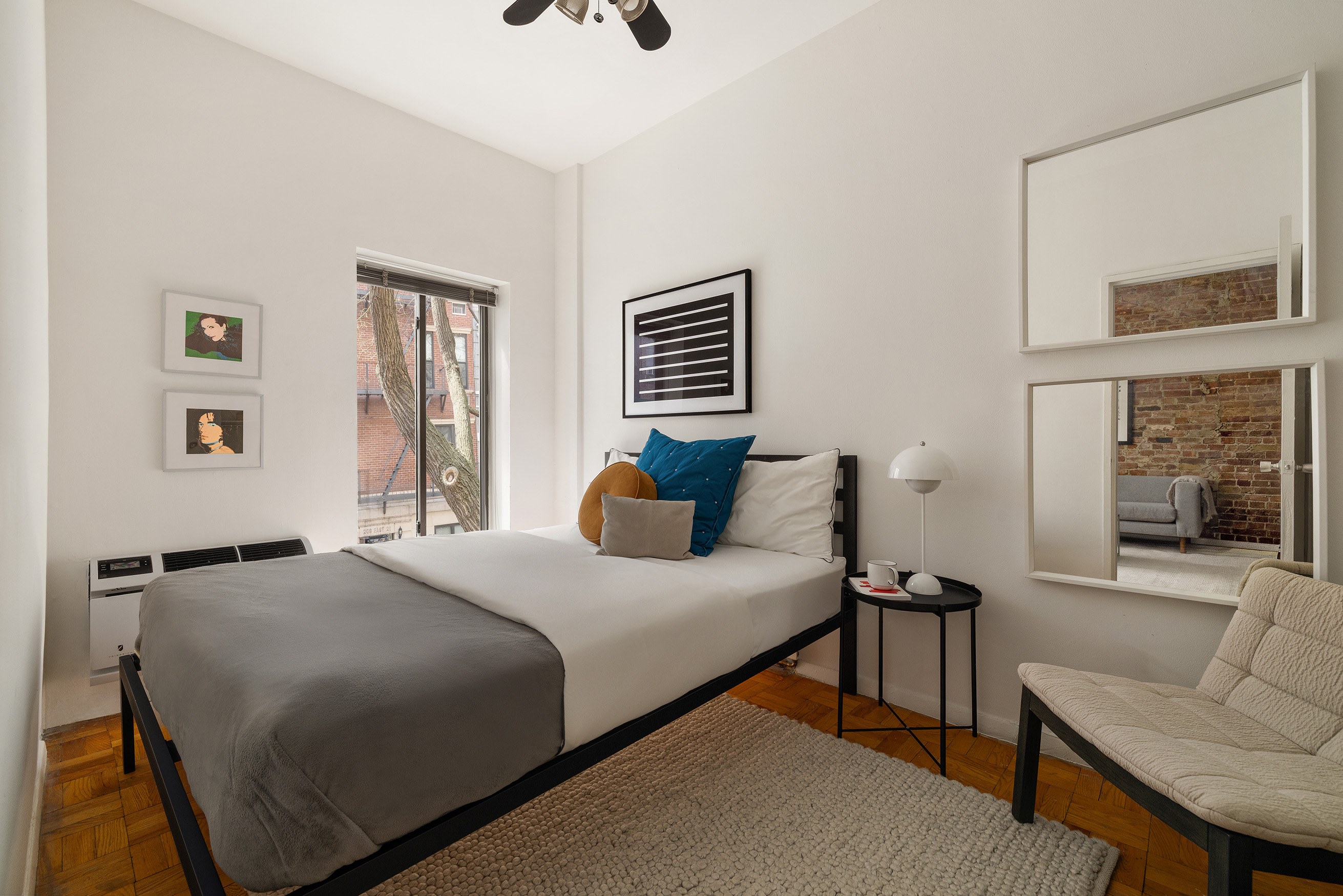 207 East 21st Street, Unit 2A Manhattan, NY 10010 - Photo 5 of 7 a bedroom with a bed and a couch