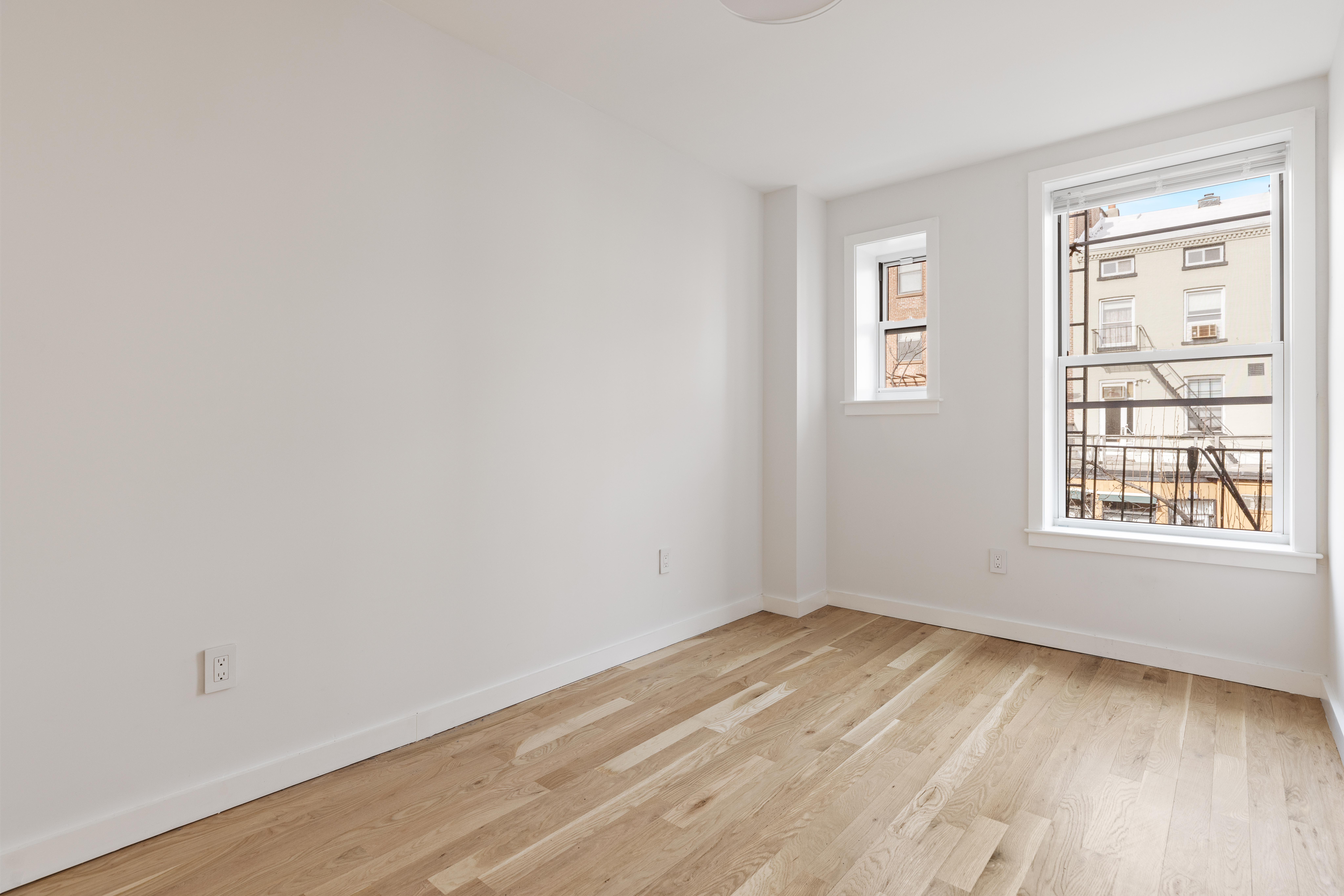 147 Atlantic Avenue, Unit 2 Brooklyn, NY 11201 - Photo 4 of 8 an empty room with wooden floor and windows