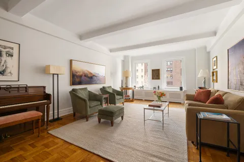 a living room with furniture and a piano