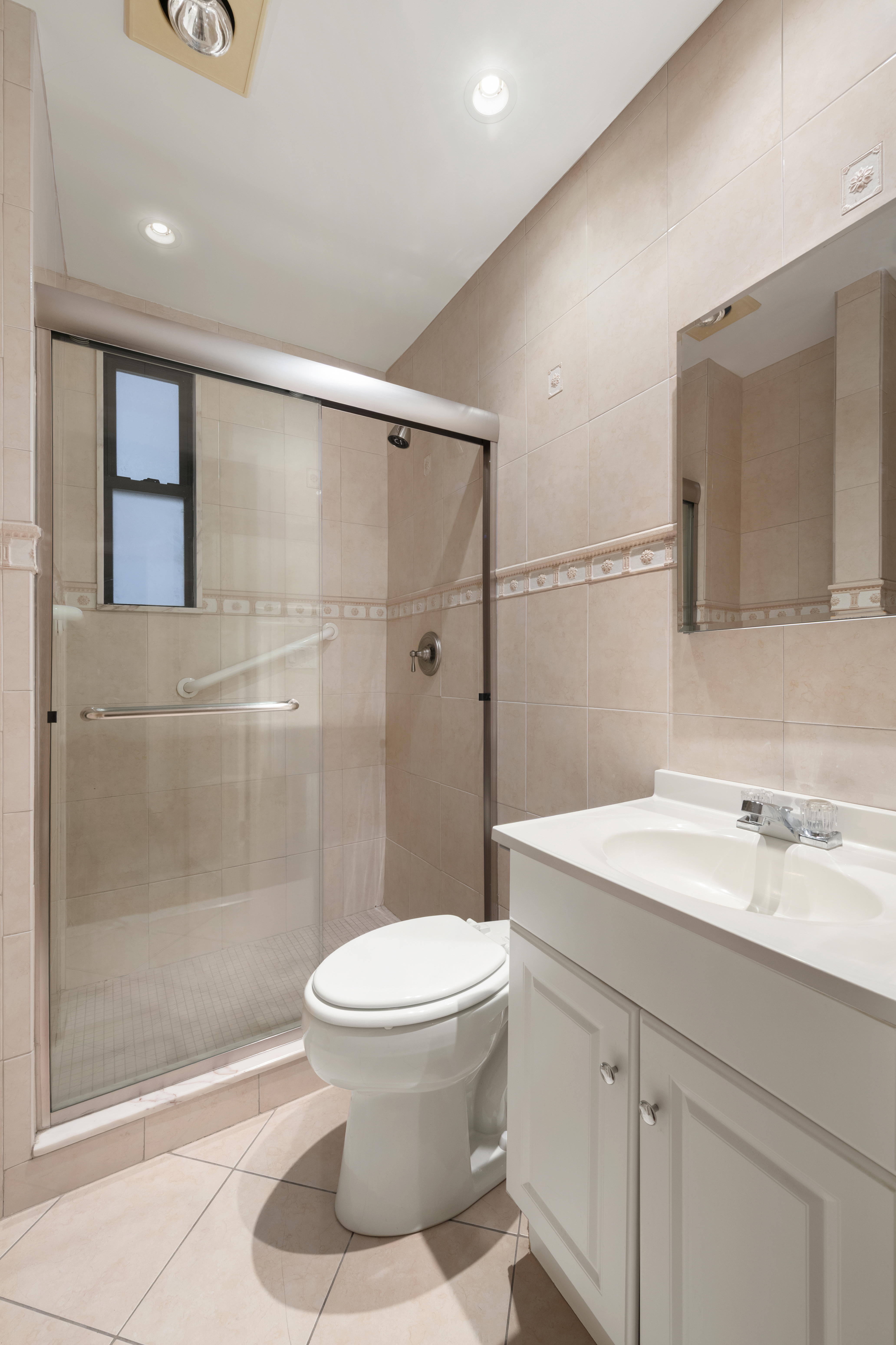 545 West End Avenue, Unit 4B Manhattan, NY 10024 - Photo 6 of 8 a bathroom with a sink a toilet and shower