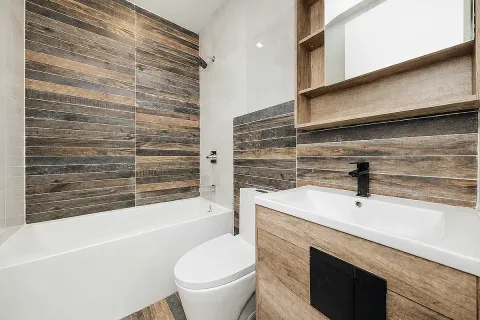 a bathroom with a sink a toilet and bathtub