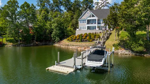a view of a house with a yard from a lake view