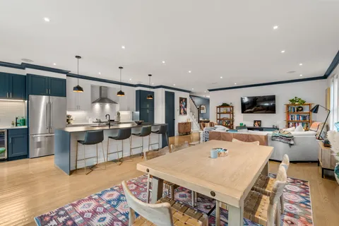 a large kitchen with a table and chairs