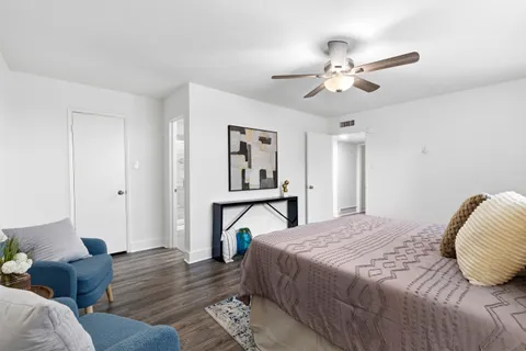 a bed room with a bed and a chair