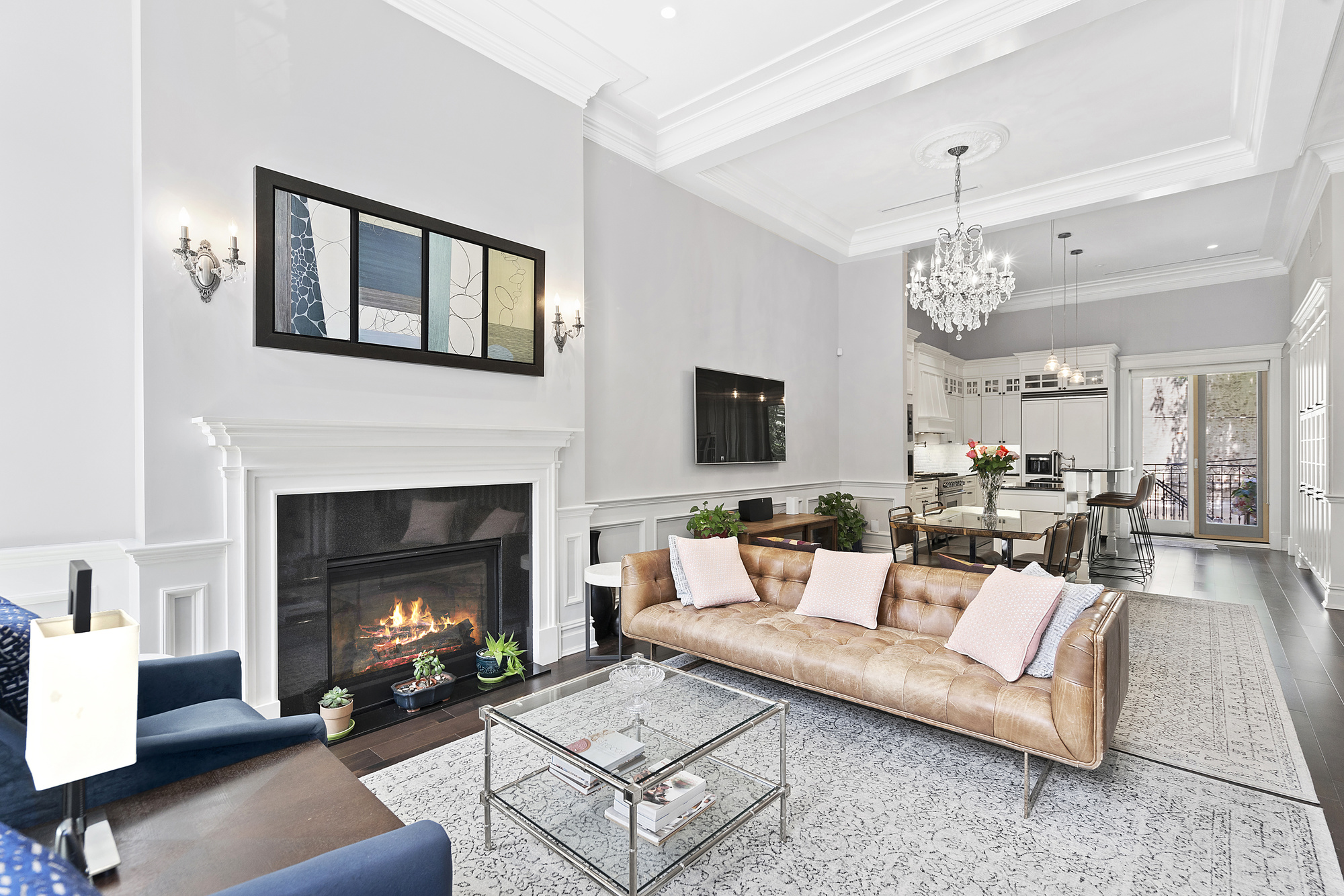 a living room with furniture a fireplace and a window