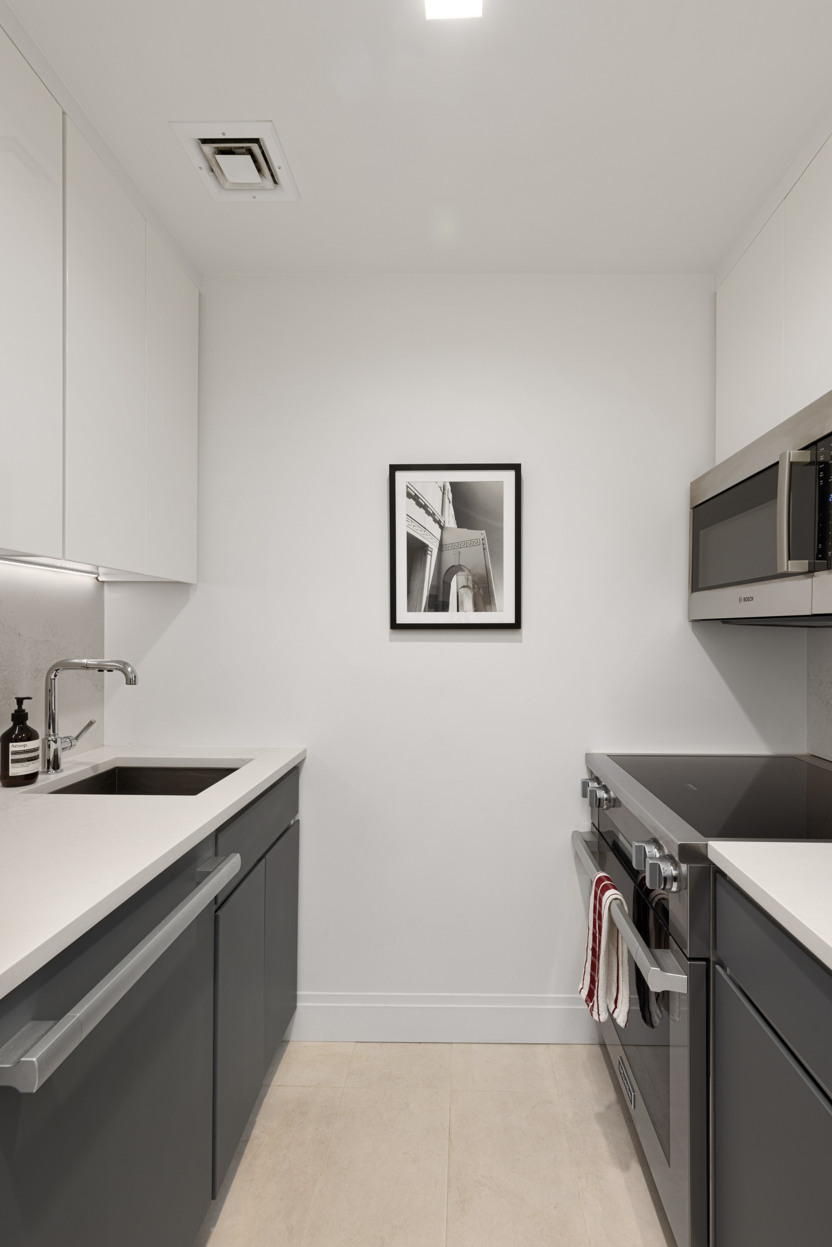 23 East 10th Street, Unit 3B Manhattan, NY 10003 - Photo 3 of 6 a kitchen that has a sink and a stove
